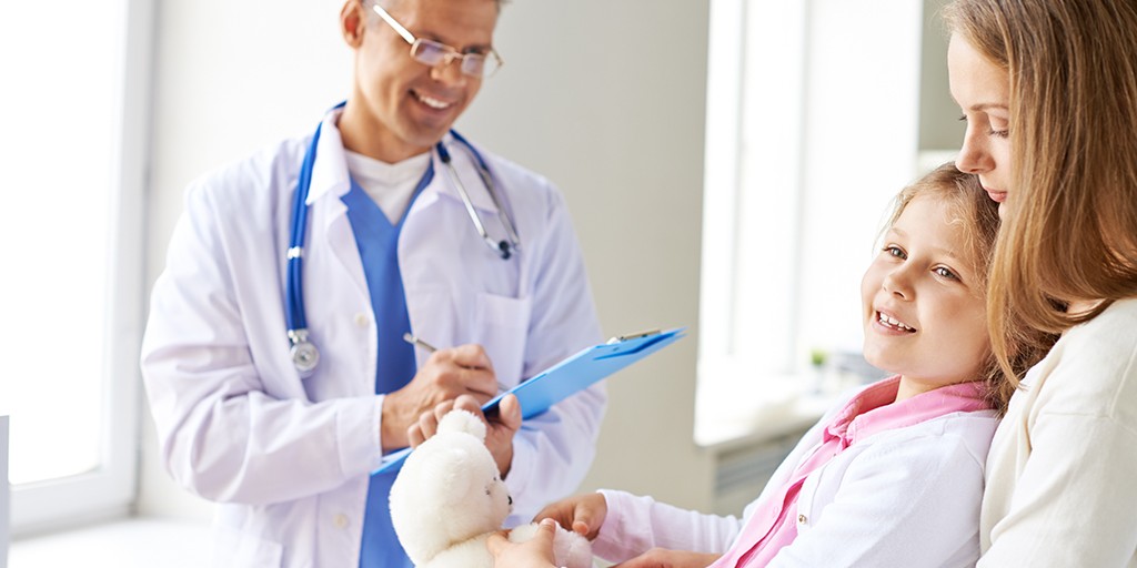 Smiling girl and her mother visiting doctor in clinics