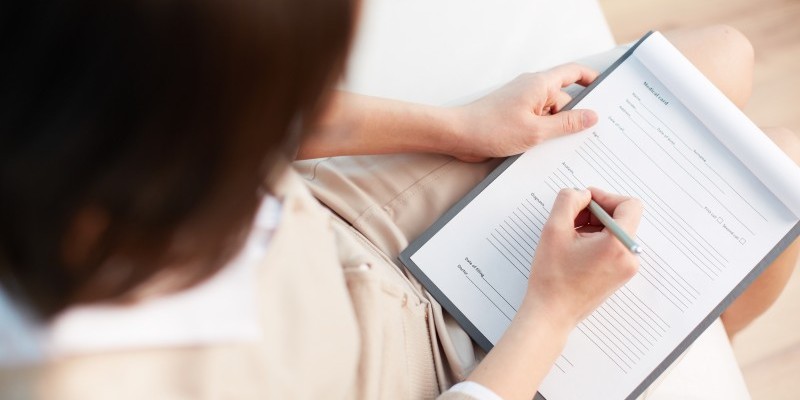 Female counselor writing down some information about her patient